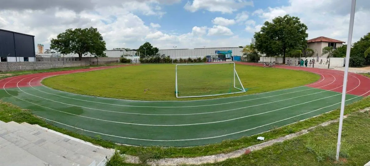 Financial District: soccer ground and running track with school buildings behind